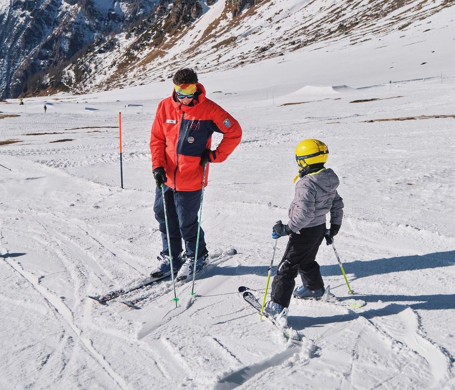 Ski instructor coaching a child on the slopes of San Domenico, Varzo